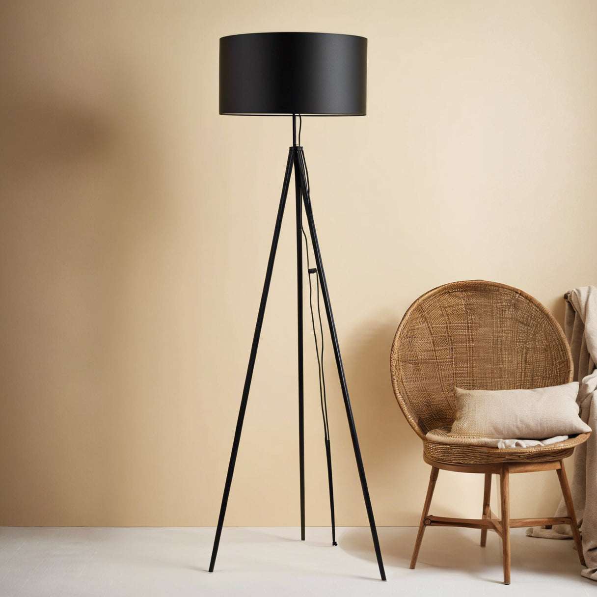 Modern black tripod floor lamp beside round wicker chair in minimalist room
