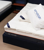 Comfortable mattress topped with white bedding and pillows, indoor bedroom setting