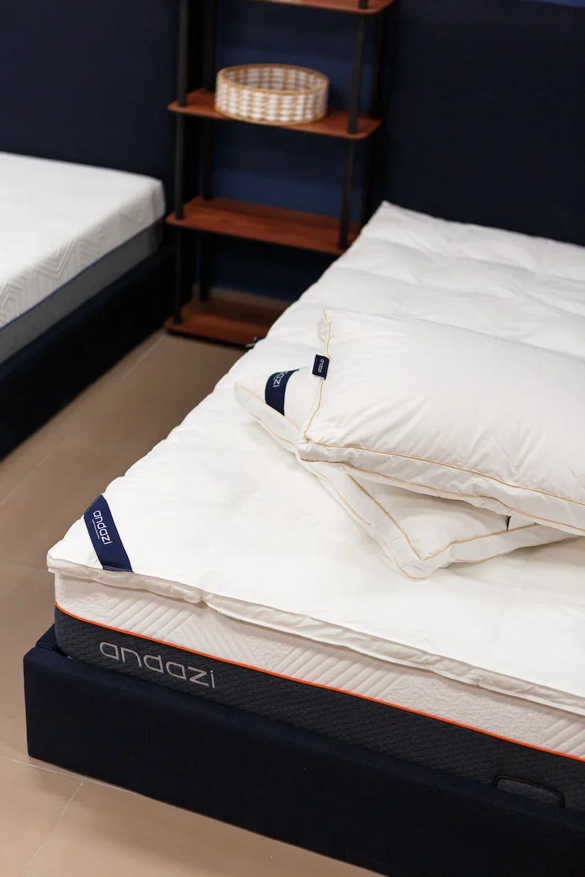 Comfortable white mattress with two soft pillows on modern bed in cozy bedroom setting