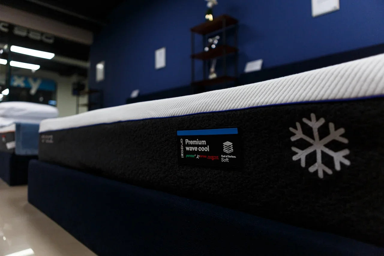 Premium wave cool mattress with soft feel and cooling symbol in a showroom setting