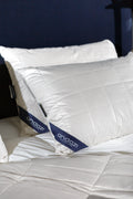 White quilted pillows and duvet on a bed, featuring Andazi label, bedroom setting