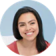 Smiling woman with dark hair in a bright room, lifestyle and relaxation theme