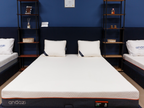 Modern bedroom with a memory foam mattress, two pillows, and navy blue decor