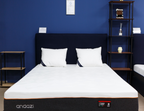 Modern bedroom with a premium comfort mattress, black bed frame, and white pillows