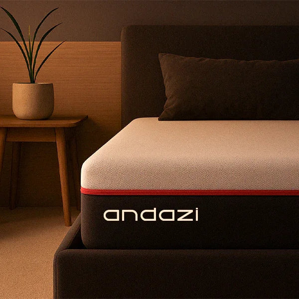 Modern foam mattress on bed frame in cozy bedroom setting, 'andazi' logo visible.